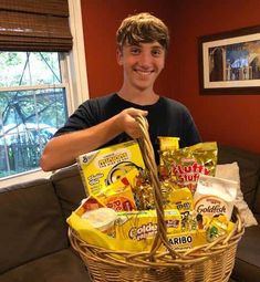 a man holding a basket full of snacks