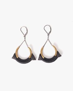 pair of black and gold earrings with metal hoops hanging from the side, on a white background