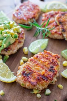 crab cakes with corn and limes on a cutting board, ready to be eaten