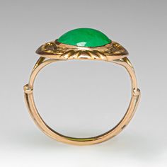 This awesome vintage ring features engraved floral details and contains one (1) oval cabochon cut natural jadeite jade set into a bezel. The ring measures 19.8mm at the top, rises 3.5mm above the finger, tapering to 1.2mm wide and 1.1mm thick at the base of the shank. This ring is currently a size 2.5 and can be sized up. Classic Oval Engraved Emerald Ring, Oval Engraved Green Emerald Ring, Engraved Oval Green Emerald Ring, Green Vintage Signet Ring For Wedding, Vintage Oval Emerald Ring Engraved, Green Oval Engraved Rings, Vintage Oval Emerald Ring For Formal Occasions, Elegant Oval Engraved Emerald Ring, Formal Vintage Emerald Ring With Oval Cabochon