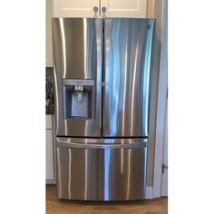 a stainless steel refrigerator with ice and water dispenser on the front door