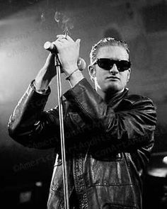 a man with sunglasses on holding a microphone