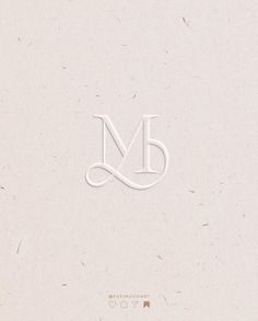 the letter m is made up of white paper and has an elegant design on it