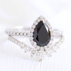 a black diamond ring set on top of a white background with the words bridal ring set available