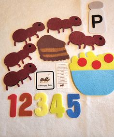 the numbers are made out of felt and have animals on them, as well as letters