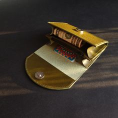 A compact, sturdy, smooth surface leather wallet for a minimalist who prefers having the mostly used cards yet with some room for coins and bills. Made of Buttero Dollaro leather, this olive green wallet will offer a nice to the touch feel and a pinch of elegance. Gold Leather Bags With Card Slots, Green Wallets With Card Slots For Daily Use, Green Wallets With Card Slots As A Gift, Green Wallets With Card Slots, Green Wallets With Card Slots For Gift, Gold Bifold Coin Purse For Everyday Use, Green Wallets Perfect As Gifts, Green Wallet With Rfid Blocking As A Gift, Green Daily Use Wallet With Card Slots