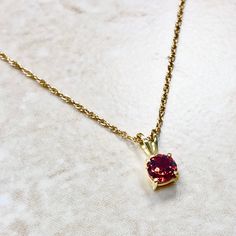 Beautiful 14 karat yellow gold pendant necklace featuring a natural 5 mm round garnet, the birthstone for January. The gemstone weighs approximately 0.60 carat. Weighs 0.89 gram. Birthstone: January. Condition: Brand New. - 14 day return policy, no questions asked. - Free insured shipping in the US. - International shipping available. Visit our website for more details about our company: www.weiljewelry.com January Birthstone Necklace, Emerald Eternity Band, Solitaire Pendant Necklace, Garnet Pendant, Garnet Necklace, January Birthstone, Solitaire Pendant, Yellow Gold Chain, Yellow Gold Pendants