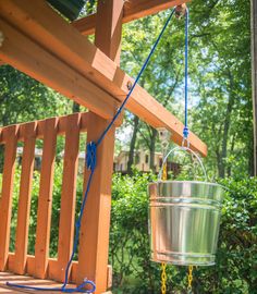 a bucket hanging from the side of a wooden porch