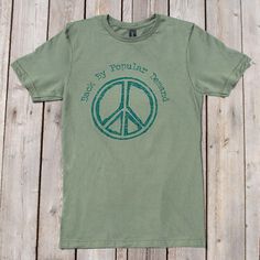 It is all about supply and demand, right? So, Back By Popular Demand, we give you this peaceful t shirt. Printed on an ultra soft, 100% cotton tee, is the phrase "Back by Popular Demand" written above a distressed peace sign. Go forth and wear in peace. Buffalo Sandals, Supply And Demand, Army Cap, Cotton Cargo Pants, In Peace, Peace Sign, Art Music, Cotton Weaving, Suede Leather