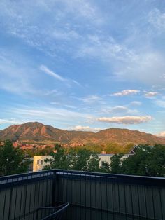 the mountains are in the distance as seen from an apartment balcony