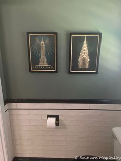 two pictures on the wall above a toilet in a bathroom