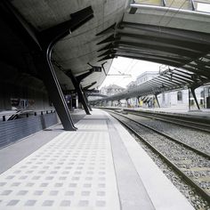 an empty train station with tracks running through it