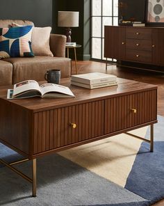 a coffee table with books on it in a living room