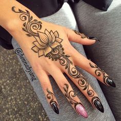 a woman's hand with black and white designs on it