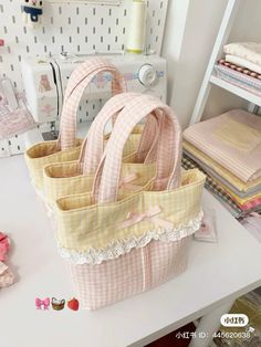 three bags sitting on top of a table next to sewing machines and thread spools