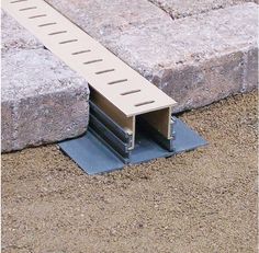 an image of a concrete block with metal grating on it's side and the bottom section missing