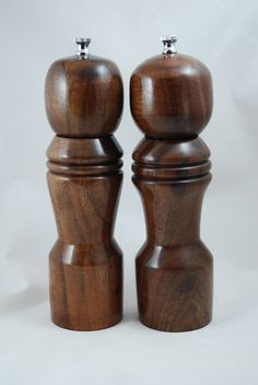 two wooden salt and pepper shakers on a white background