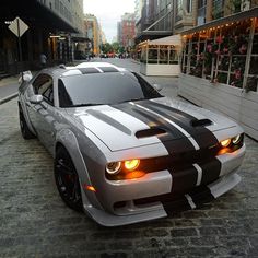 a silver and black car is parked on the street