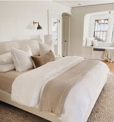 a large bed sitting in the middle of a bedroom