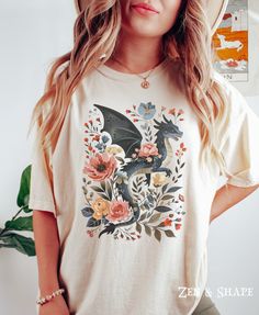 Retro Dragon Floral Comfort Colors Shirt, Cottagecore Dragon T-Shirt, Cute Black Dragon Tee, Dragon Anime TShirt, Gift For Dragon Lover PLEASE SIZE UP FOR AN OVERSIZED FIT If you are looking for an oversized "T-shirt Dress" look, we recommend sizing up 2 sizes. Comfort Colors introduces its garment-dyed t-shirt; a fully customizable tee made 100% with ring-spun cotton.  The soft-washed, garment-dyed fabric brings extra coziness to your wardrobe while the relaxed fit makes it an excellent daily c Dragon Cottagecore, Cottagecore Dragon, Dragon Tshirt, Floral Dragon, Dragon Anime, Oversized T Shirt Dress, Vintage Dragon, Anime Tshirt, Dragon Lover