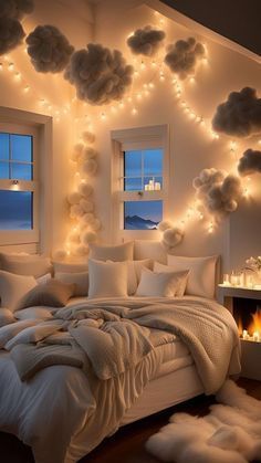 a bedroom decorated in white with lights on the ceiling and fur rugs around the bed