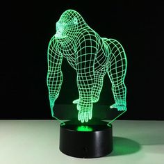 a 3d image of a gorilla is shown on a black stand with green light in the dark