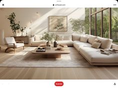 an image of a living room setting with furniture and plants on the coffee table in front of large windows