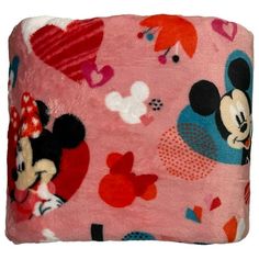 a pink blanket with mickey and minnie mouses on it, all in different colors