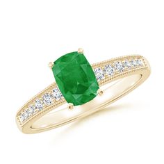 a gold ring with an emerald and diamonds on the band, set in yellow gold