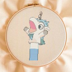 a cross stitch pattern with an elephant holding a cup