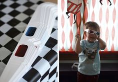 a little boy standing in front of a window next to a black and white checkered floor