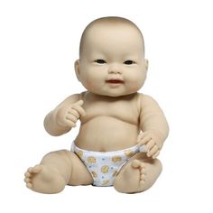 a baby doll sitting on the ground wearing a diaper