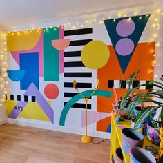 a brightly colored room with potted plants and lights