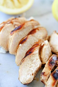 sliced chicken sitting on top of a white plate