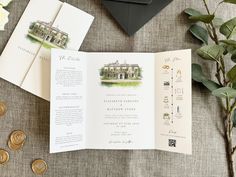 an open brochure sitting on top of a table next to coins and flowers