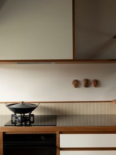 a stove top oven sitting inside of a kitchen next to a wall mounted pot holder