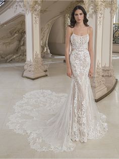 a woman in a white wedding dress standing on a marble floor next to pillars and stairs