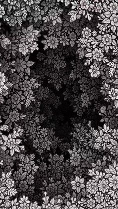 black and white flowers are arranged in the center of a square pattern on a dark background