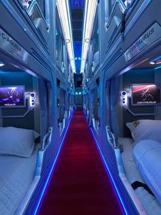 the inside of an airplane with red carpet and white beds