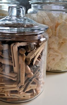 two glass jars filled with different types of wood shavings