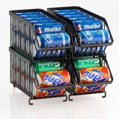 four soda cans are stacked in a wire basket