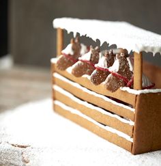 a wooden sleigh decorated with gingerbreads and powdered sugar on top