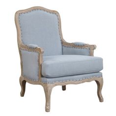 an upholstered blue chair with gold trimmings and nail polishing on the legs