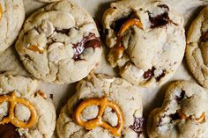 several cookies with pretzels and caramel on top are arranged in a row