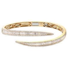 A classic look with easy elegance, this diamond bangle bracelet exudes sophistication. This stunning bracelet is crafted in 18k yellow gold and features channel set baguette cut and round cut diamonds with a total diamond weight of 3.76 carats. Diamond color G-H and VS-SI clarity. It's stackable and easy to wear. Bangle width: 6.2mm. Weight: 25.48 grams. Wrist fit: 6.5 inches. Comes with a presentable gift box and appraisal. Pave Diamond Wedding Bands, Diamond Bangle Bracelet, Bangles Making, Simple Diamonds, Diamond Bangles Bracelet, American Modern, Bangles Style, Baguette Cut Diamond, Fine Jewelry Bracelets