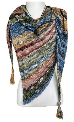 a white mannequin wearing a multicolored shawl