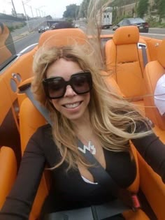 a woman sitting in the back of an orange boat