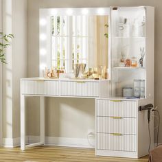 a white vanity with lights on it in a room next to a chair and potted plant