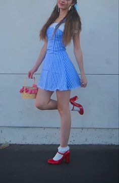 Cute trendy Dorothy from Wizard of Oz Halloween costume with red heels, white socks, blue gingham, dress, white, puff sleeve shirt, and cute pigtail with ribbon hairstyle Dorothy Costume Women, Dorothy Costume Womens, Dorthory Wizard Of Oz Costume, Dorthy Costume Aesthetic, Halloween Dorothy Costume, Soft Girl Halloween Costumes, Dorothea Costume, Dorothy Hairstyle, Womens Dorothy Costume