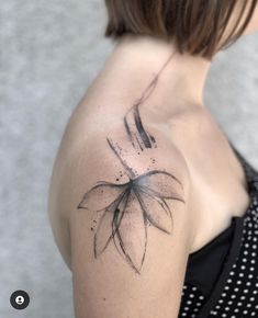 a woman with a black and white flower tattoo on her shoulder